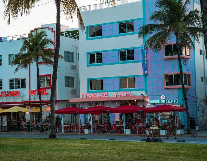 Colorful Miami beachfront with hotels and palm trees at dusk