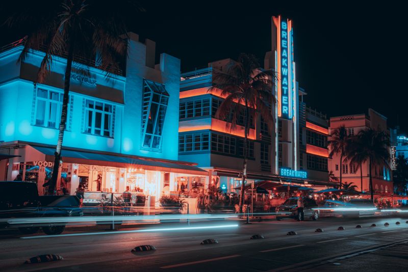 Breakwater Hotel neon sign with car light trails on Miami's Ocean Drive