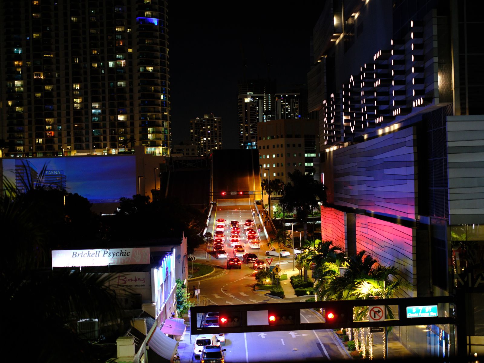 Night view of Miami's Brickell district with city lights and traffic trails