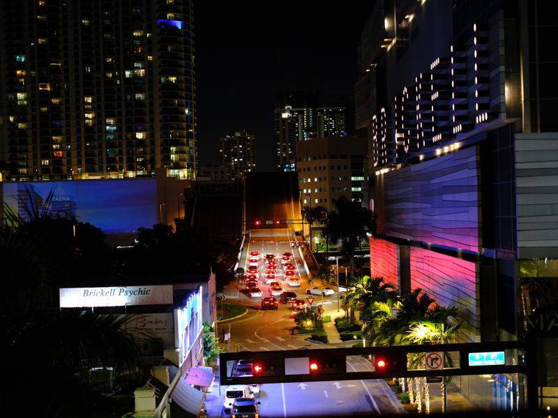 Night view of Miami's Brickell district with city lights and traffic trails