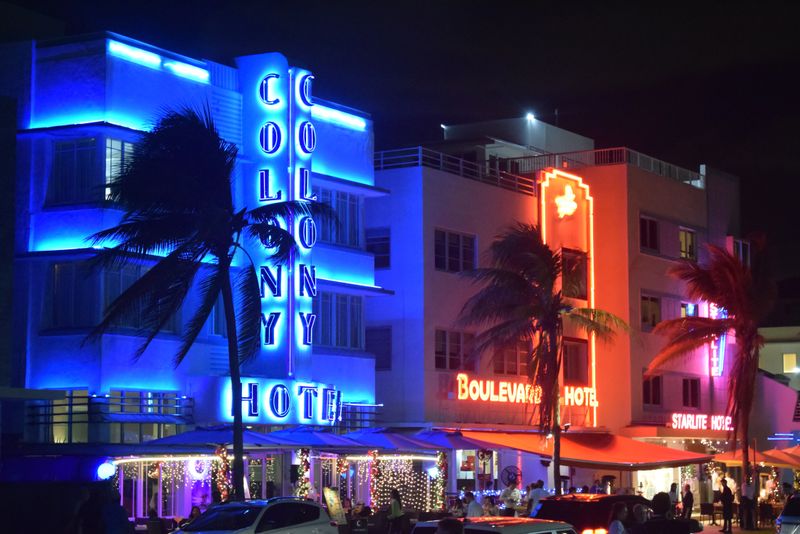 Neon-lit hotels glowing along the Miami Beach strip at night