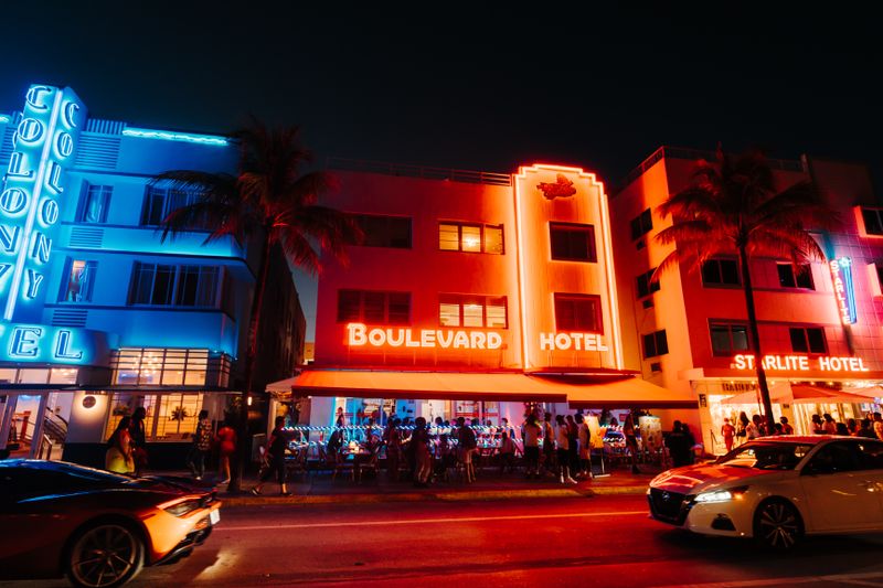 Lit-up art deco hotels and nightlife along Miami's Ocean Drive at night