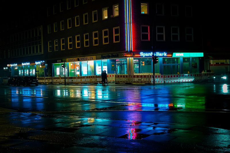 Colorful neon reflections on wet streets in a city at night